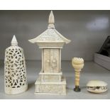 Four early 20thC carved ivory items: to include a canopied and enclosed shrine, featuring Buddha,