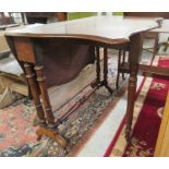 A late Victorian walnut Sutherland table, the top with a serpentine edge,