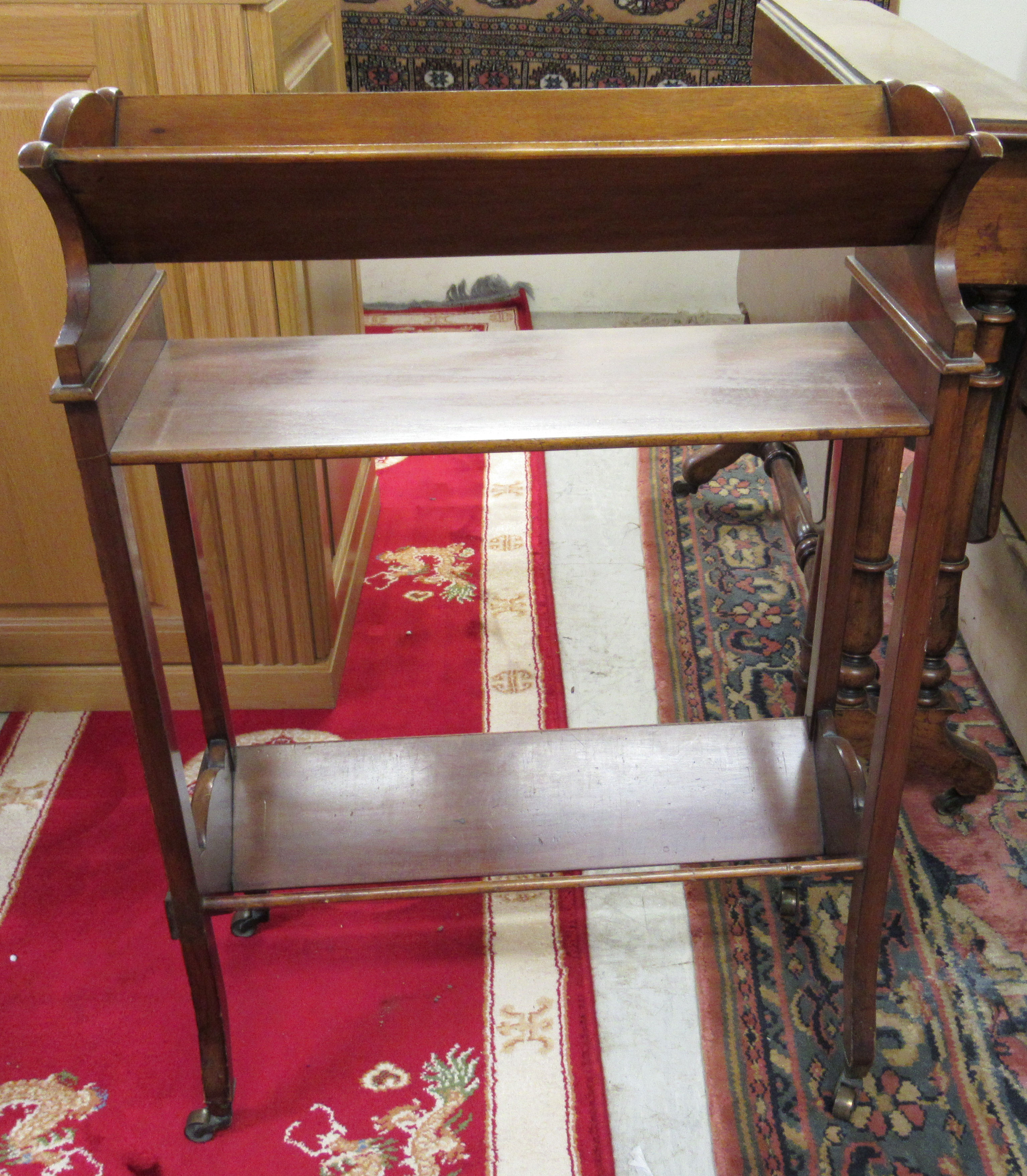 An Edwardian mahogany trough design bookstand,