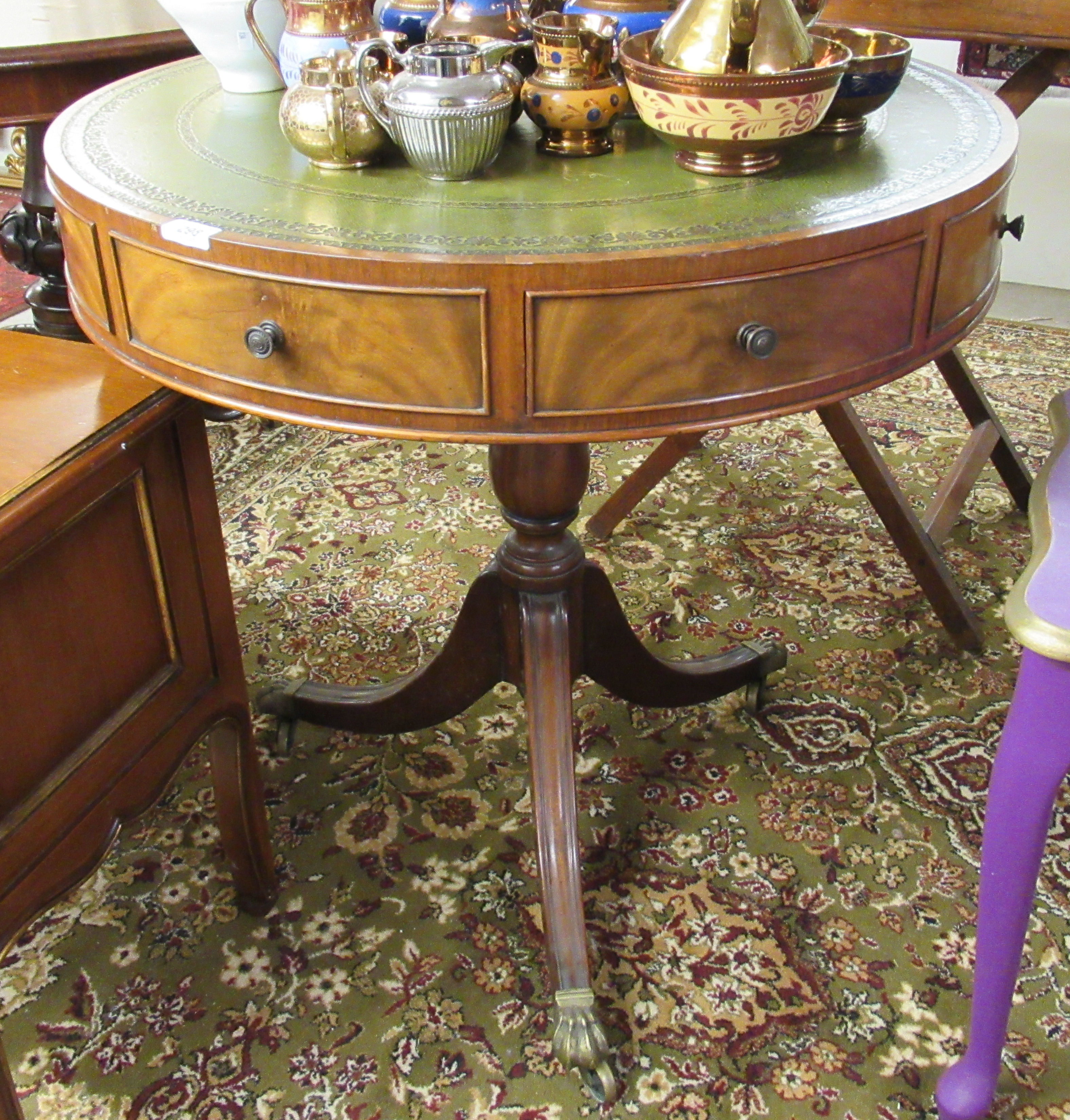 A modern Regency style mahogany drum table, the top set with a tooled green hide scriber,