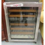 A Sub Zero brushed stainless steel cased wine fridge with a glass door and trays 33.