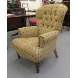 A Victorian style spoonback armchair, upholstered in patterned fabric,