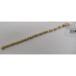 A 14ct gold bracelet with alternating cross and diamond links, the central four,