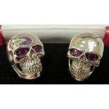 A pair of silver skull design cufflinks 11