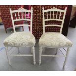 A pair of 20thC cream painted bedroom chairs with Designer's Guild cream coloured fabric