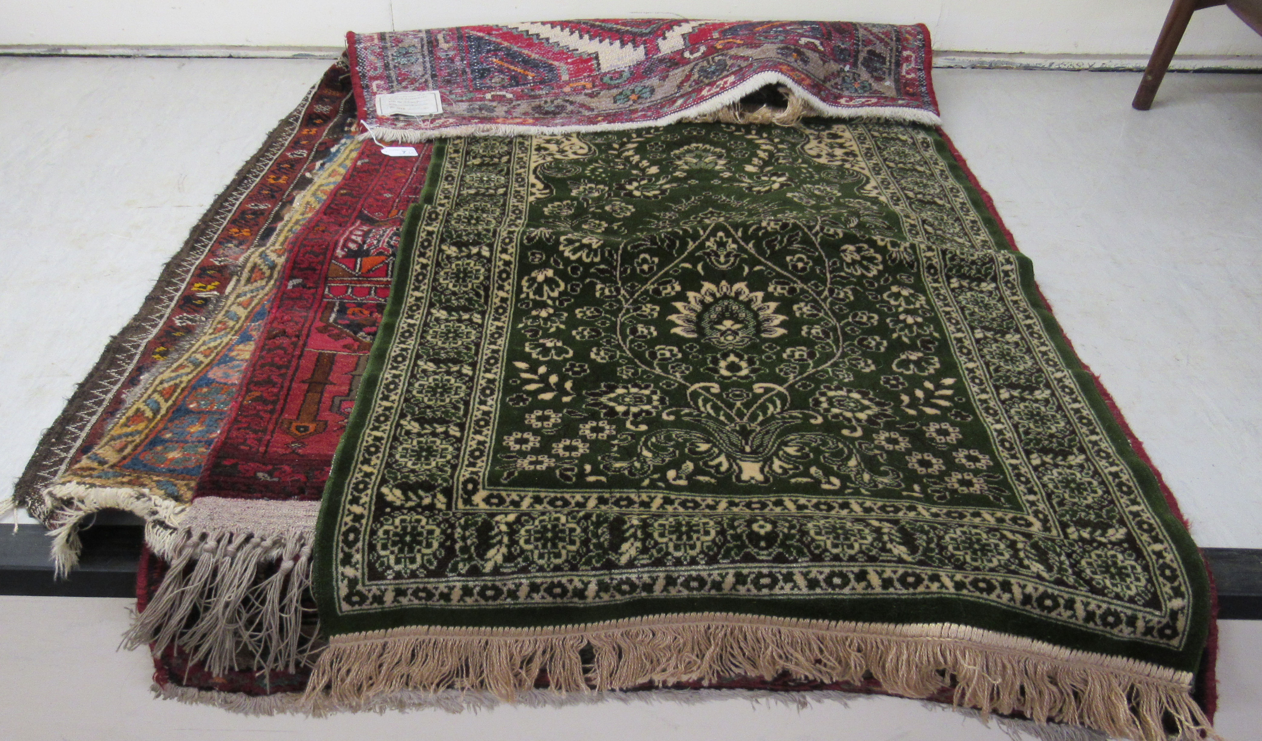 Five small Persian and other rugs, decorated in various styles,