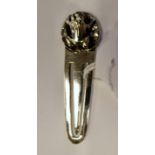 A silver bookmark with a frog finial indistinct marks 11