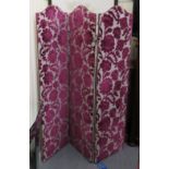 A 20thC three section room screen, upholstered in a berry cut velvet,