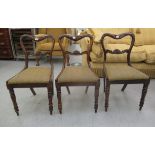 A set of three mid Victorian rosewood framed, balloon back dining chairs with upholstered seat pads,