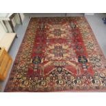 A Caucasian carpet, decorated with stylised motifs,