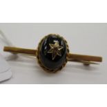 A 9ct gold bar brooch with a cabochon and garnet 11