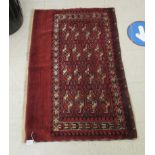 A Bokhara rug, decorated four columns of four guls,