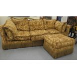 A modern three person settee with a low back and level, scrolled arms,