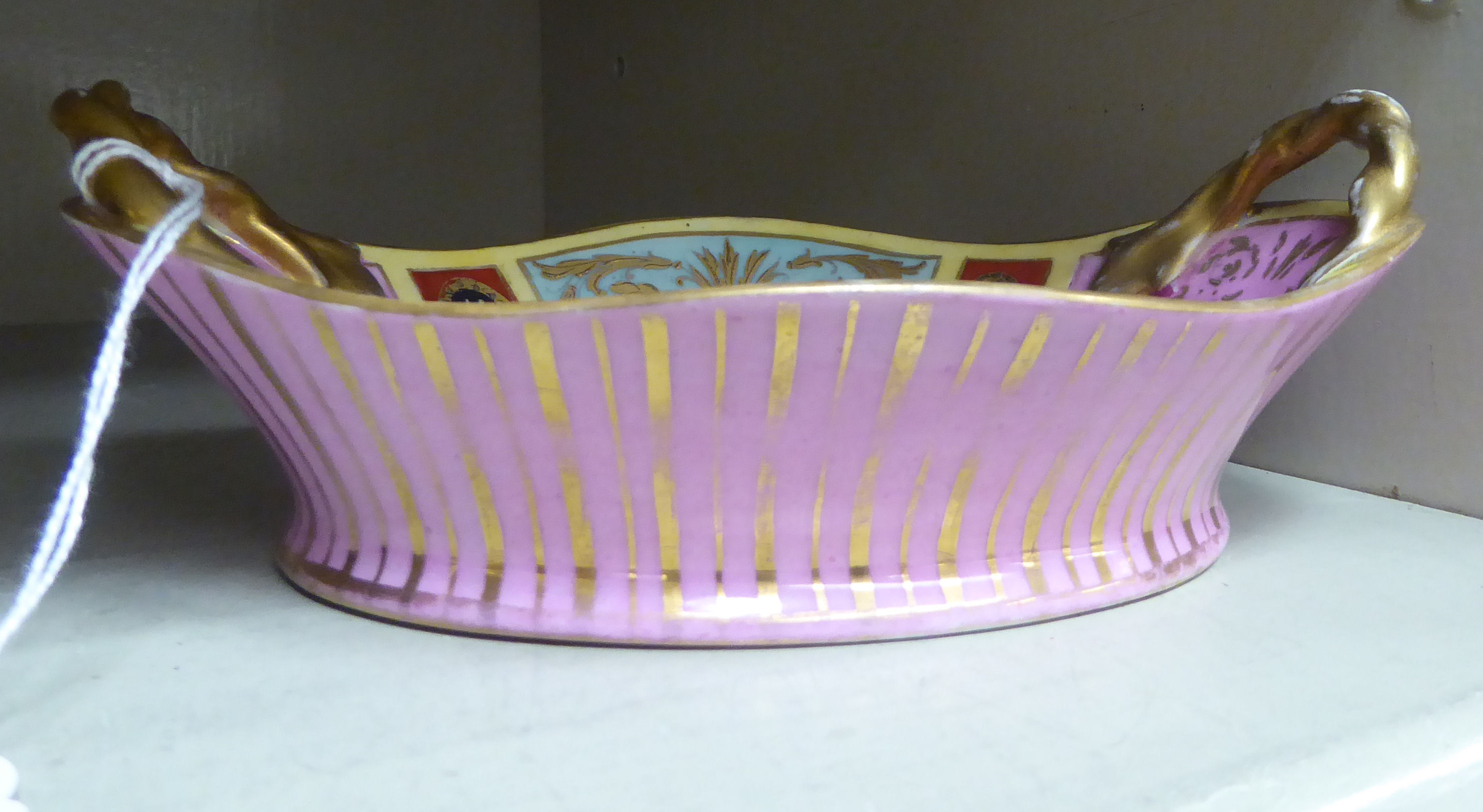 A late 19thC Vienna porcelain shallow dish with a gilded opposing ropetwist design handles,
