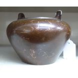 An Oriental cast and patinated bronze censer, the tapered, bulbous bowl with opposing,