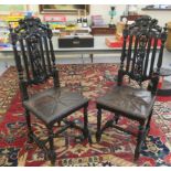 A pair of late Victorian stained oak hall chairs with a rampant lion carved crest and a splat back,