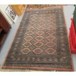 A Persian rug, decorated with repeating stylised diamond formations,