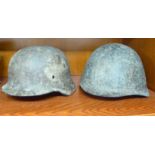World War II period steel helmets, one German,