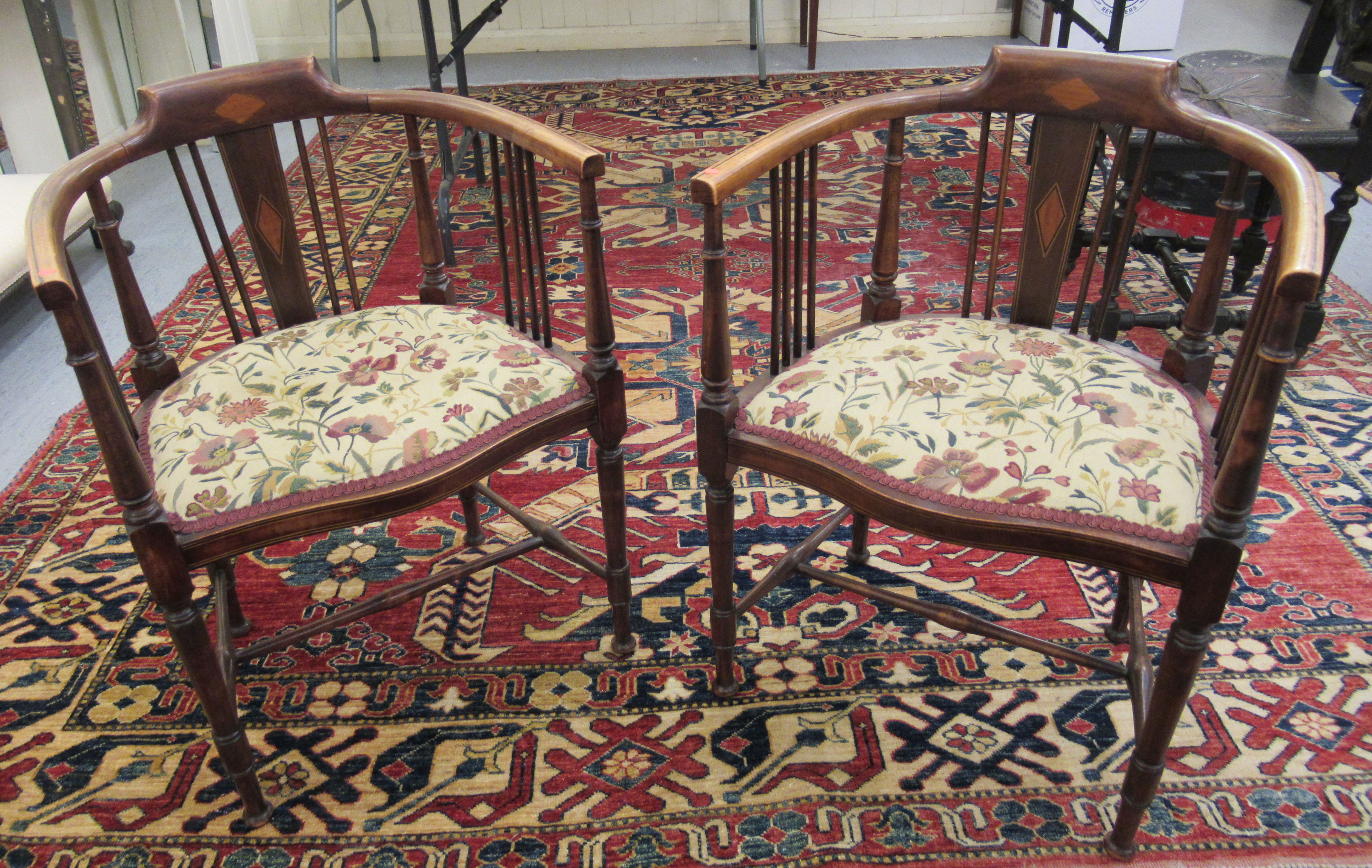 A pair of Edwardian satinwood inlaid mahogany horseshoe shaped salon chairs,