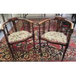 A pair of Edwardian satinwood inlaid mahogany horseshoe shaped salon chairs,