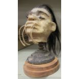 An 'antique' replica of a shrunken head, made in moulded horse hide,