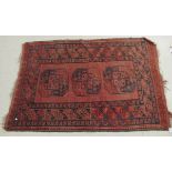An Afghan rug, decorated with three central octagonal guls,