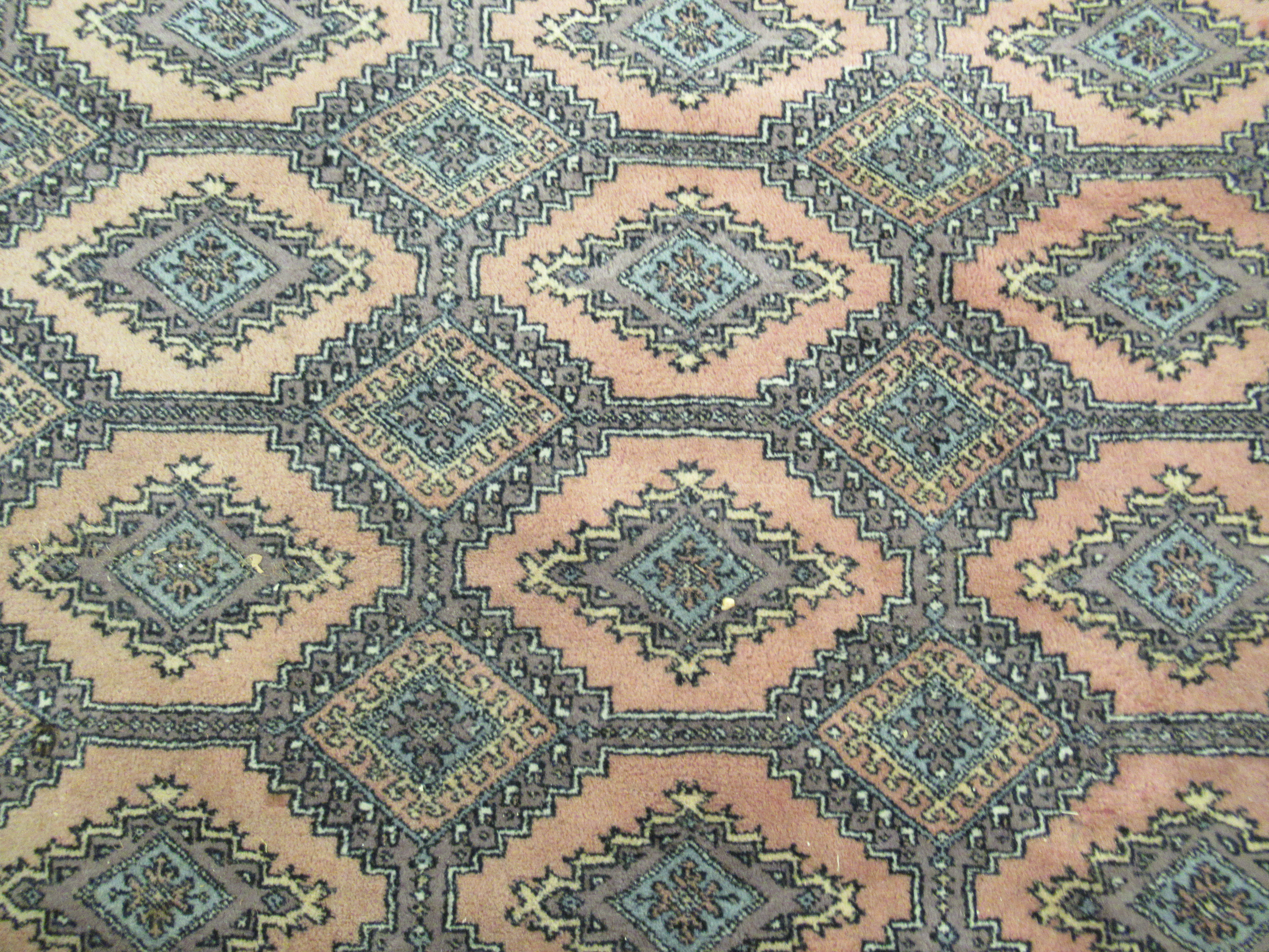 A Persian rug, decorated with repeating stylised diamond formations, - Image 3 of 4