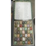 Forty nine miniature carved eggs, fashioned from different hardstone,