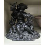 An early/mid 20thC black painted spelter group, a boy with a Billy goat,