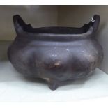 An Oriental cast and patinated bronze censer of lobed,