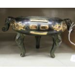 An Oriental cast and patinated green and part gilded bronze censer of shallow,