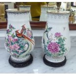 A pair of mid 20thC Chinese porcelain table lamps, each decorated with birds and peonies,