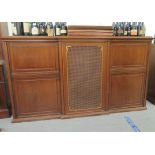 A 20thC mahogany breakfront bookcase with an arrangement of fall flaps, caned and panelled doors,