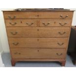 An early 20thC honey coloured oak dressing chest, comprising a frieze drawer,