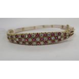 A late Victorian yellow metal diamond and ruby bangle 11