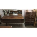 A 1960s mahogany finished dressing table with a triptych mirror, over two drawers,