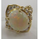 An 18ct gold ring, set with a central opal,