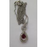 An 18ct white gold pendant, set with diamonds and a pear cut ruby,