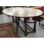 A Jacobean style oak wake table, the top with deep fall flaps,