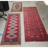 Three Persian and other rugs: to include one on a red ground 24'' x 62'' CA
