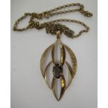 A 9ct gold leaf design pendant, set with a smokey quartz,