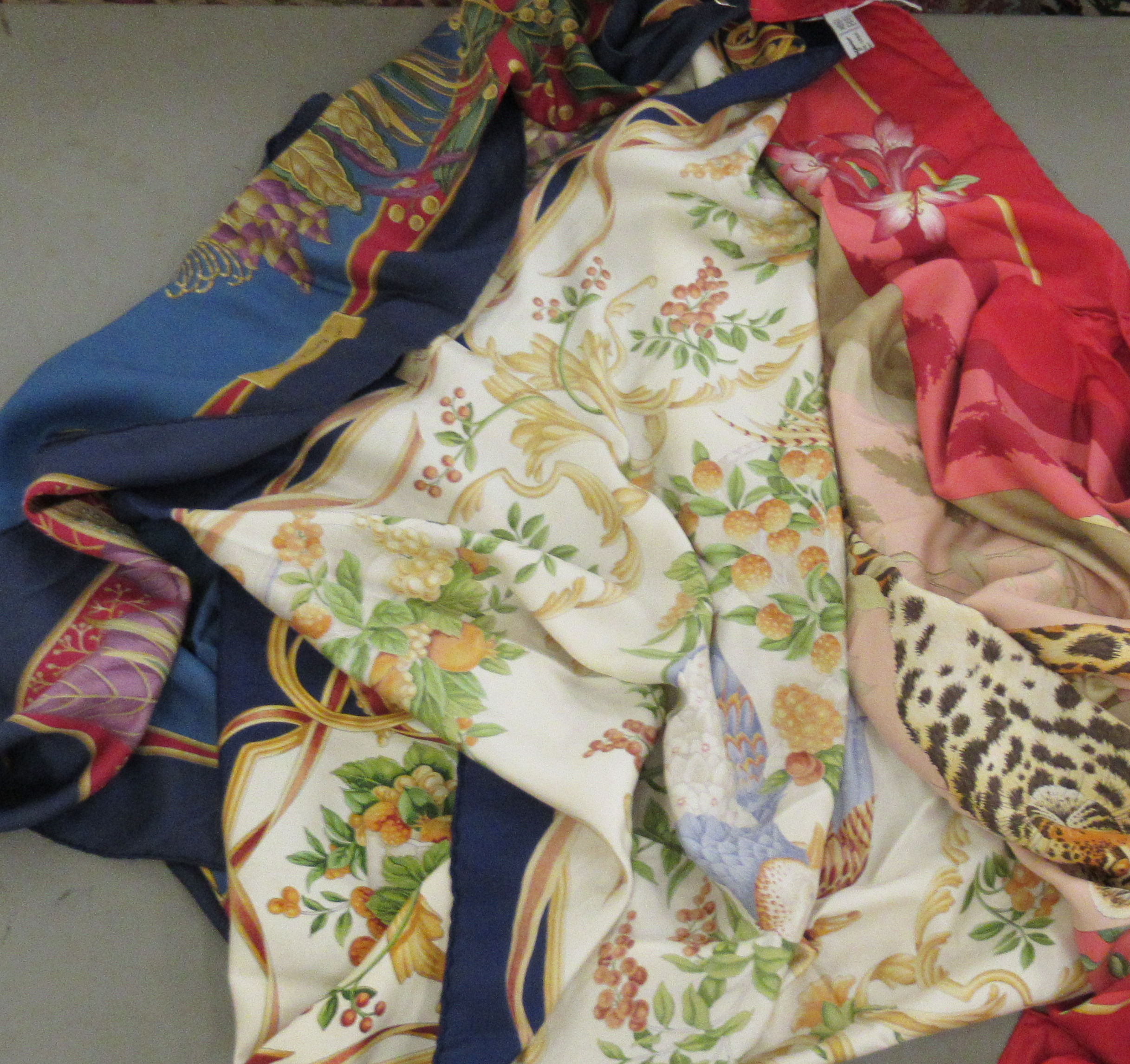 Three Salvatore Ferragamo patterned silk scarves 32''sq OS10