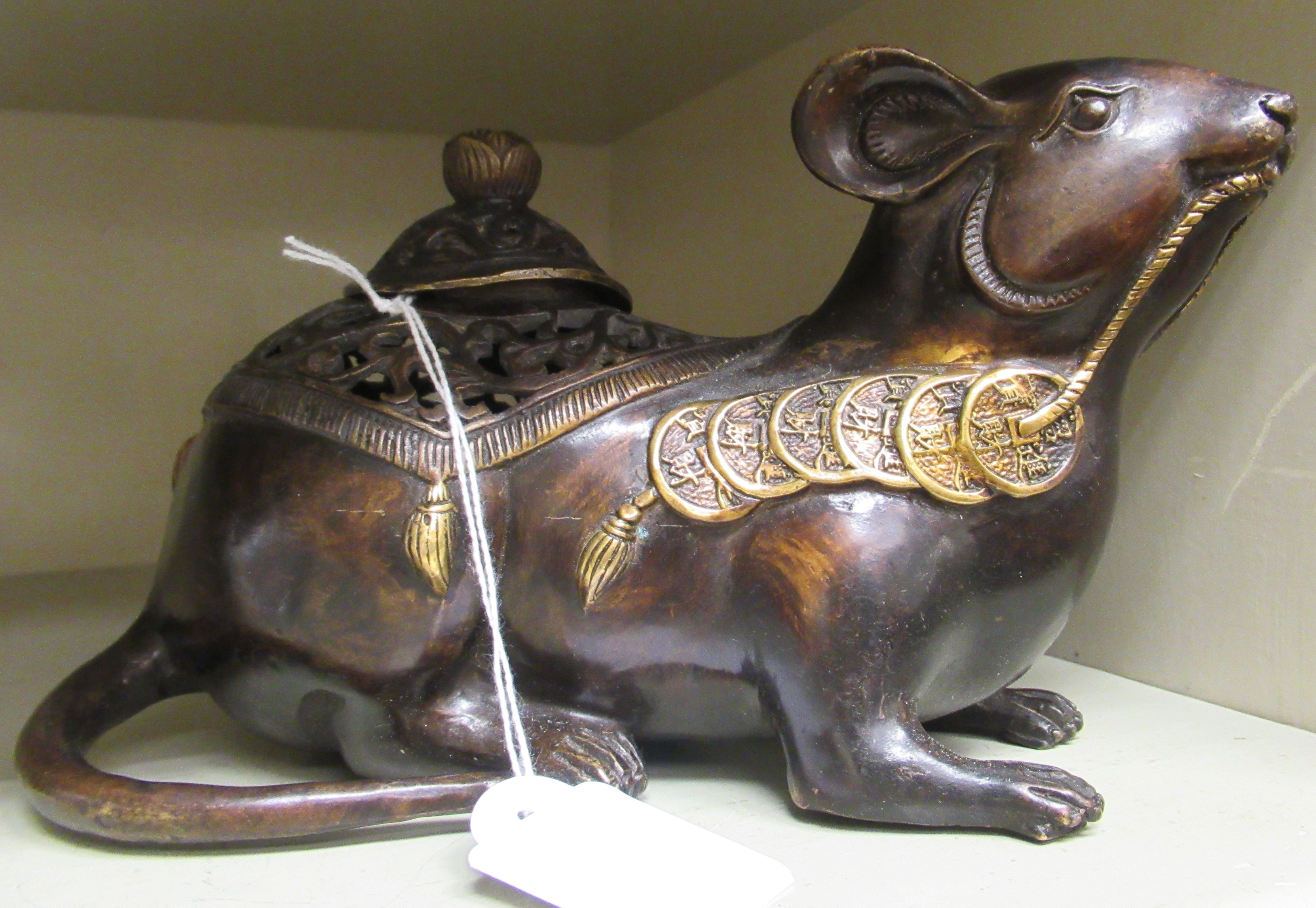 An Oriental cast and patinated and part gilded censer and cover, fashioned as a seated rodent,