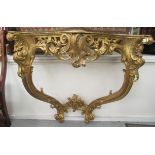 A modern 'antique' inspired gilded Rococo design serpentine front console table,