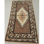 A Caucasian rug, decorated with repeating stylised designs,