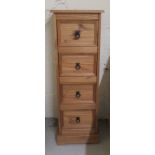 A modern waxed pine pedestal chest, comprising four equal drawers with iron handles,