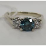 A 14ct white gold ring, the claw set central blue diamond approx.0.
