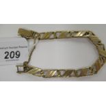 A 9ct gold bar and hoop link bark textured bracelet 11