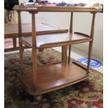 An Ercol Golden Dawn elm three tiered tea trolley,