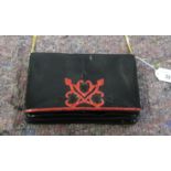 A Rene Caovilla black patent leather clutch bag with a gilt metal shoulder strap OS8